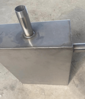 Custom stainless steel tank fabrication with welded pipe fittings for industrial liquid storage.