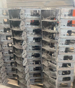 Batch production of custom metal excavator control lever brackets for heavy equipment.